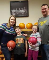 Student parent with family bowling at a ISPC event